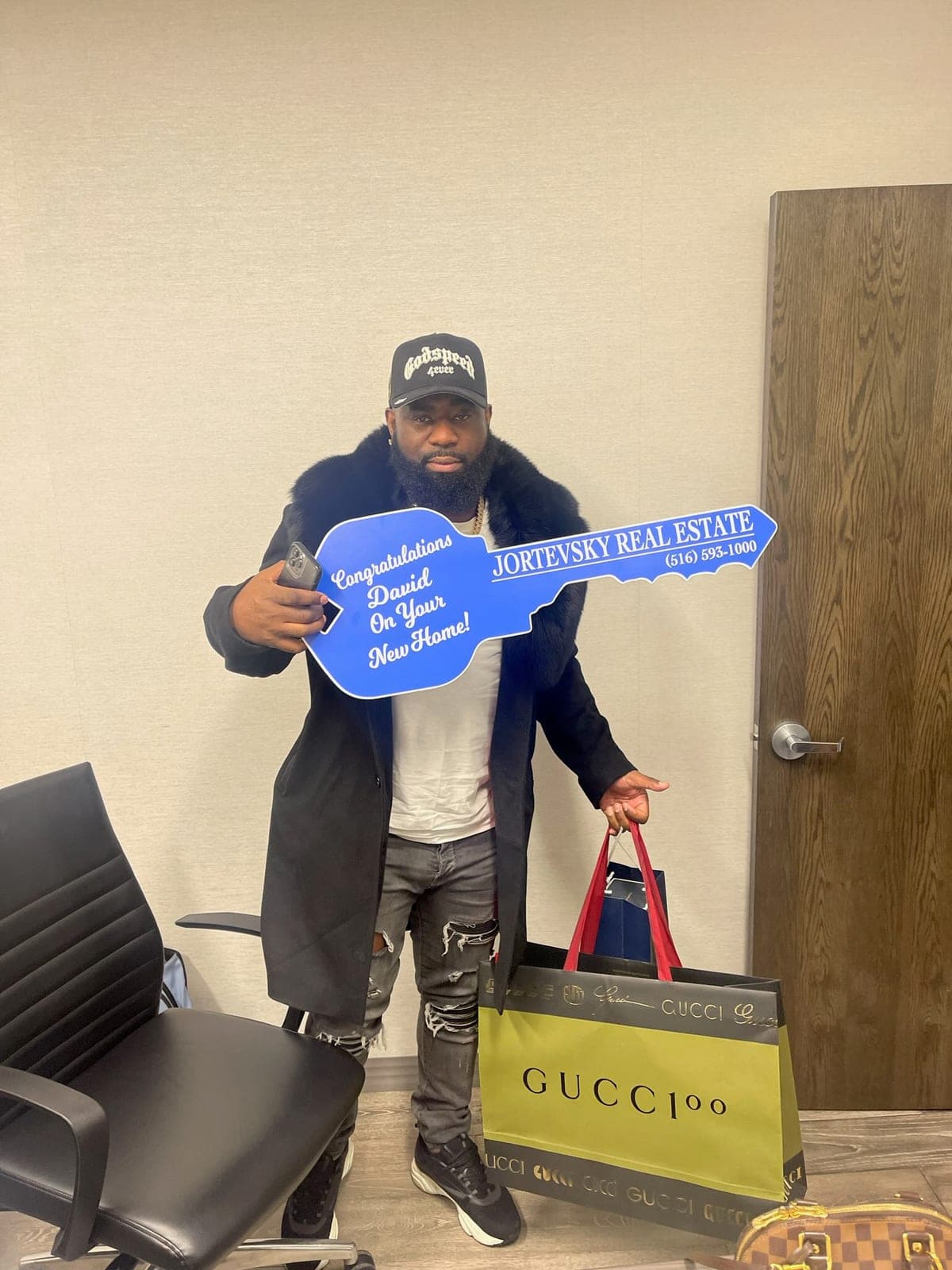 David collecting the keys to his new home at the Jortevsky Real Estate Firm office