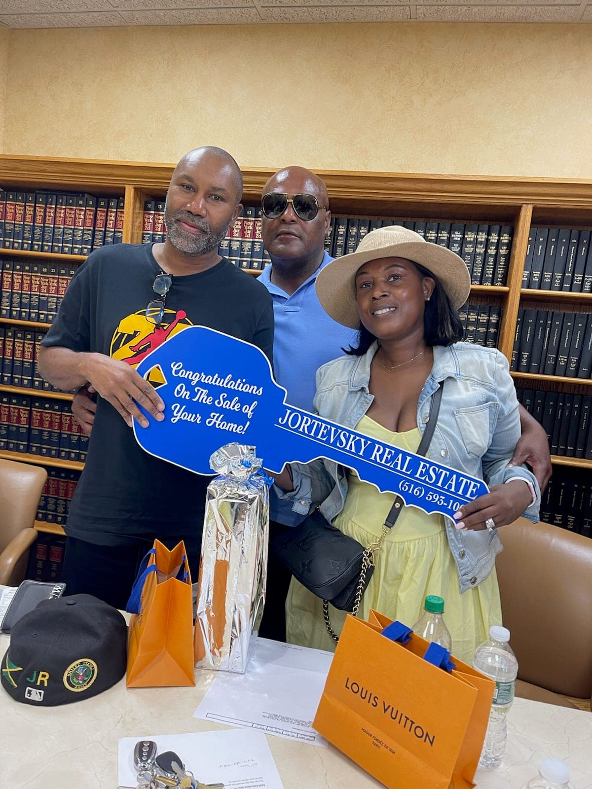 Sellers holding the Jortevsky key after completing the sale of their home